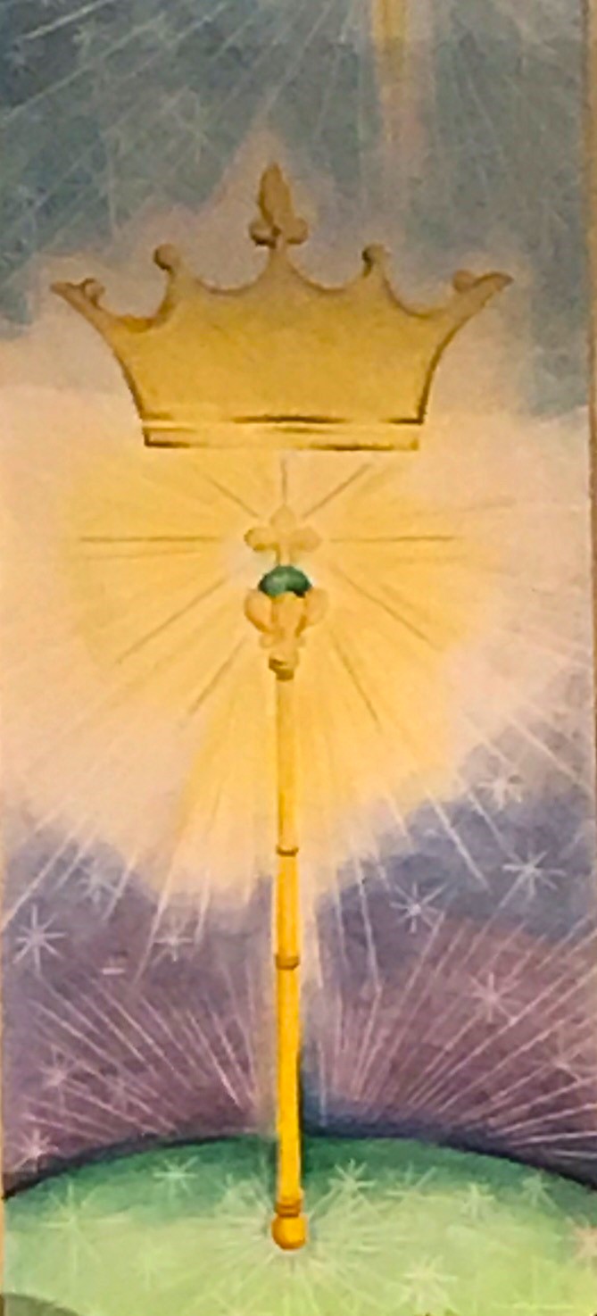 A banner showing a crown over a glowing staff.