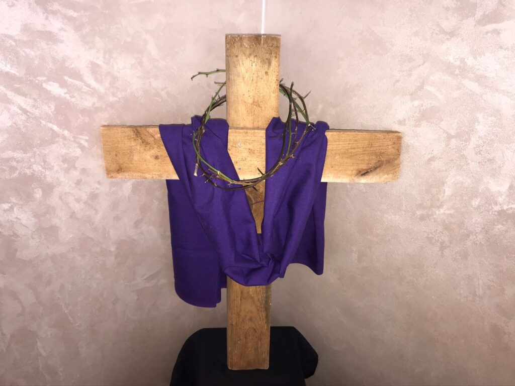 A cross draped with a purple cloth.